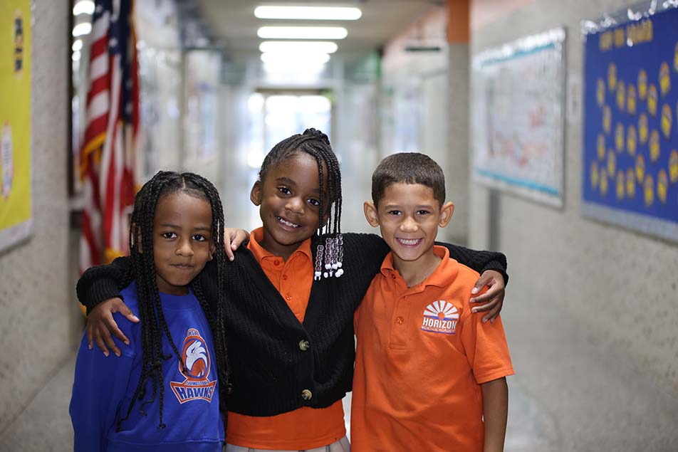 student in classroom smiling at camera