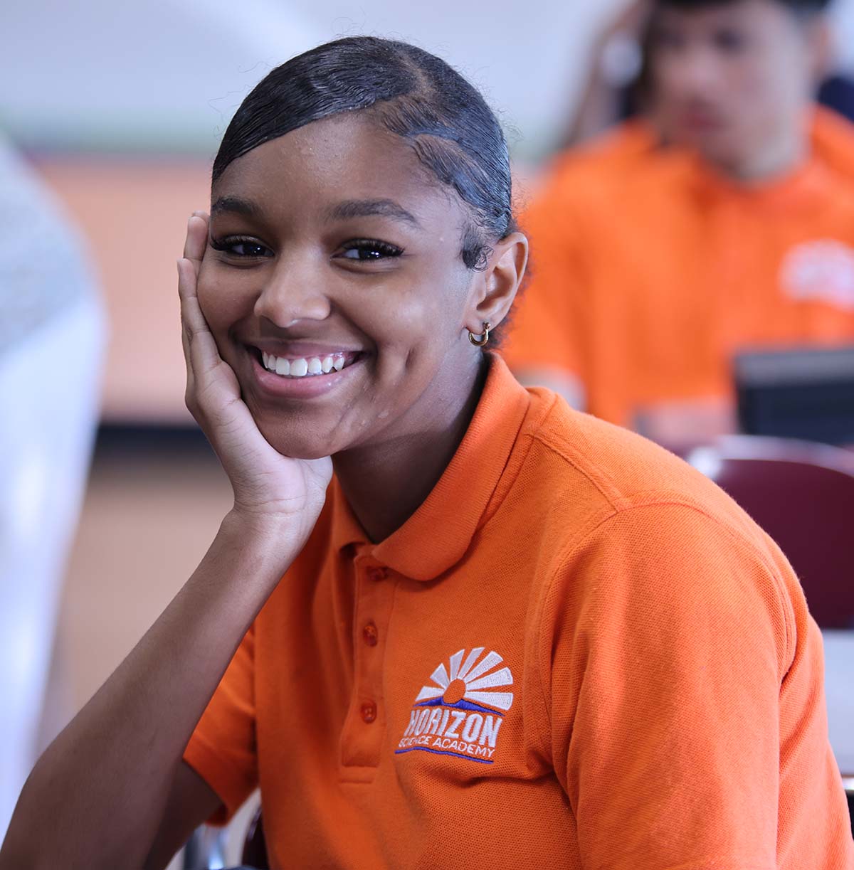 Student drawing in a classroom.