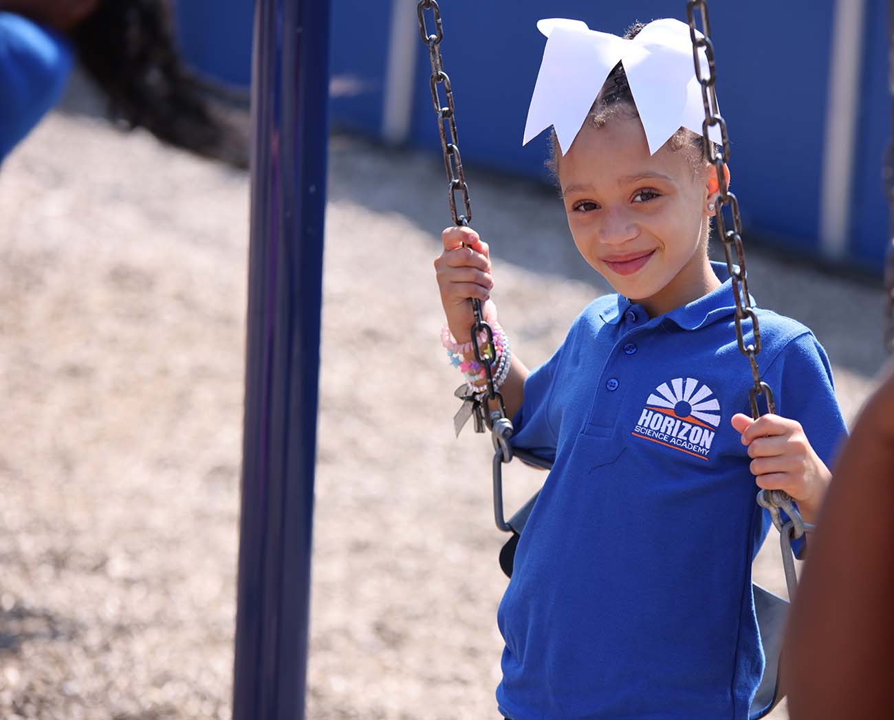 Smiling children together outdoors.